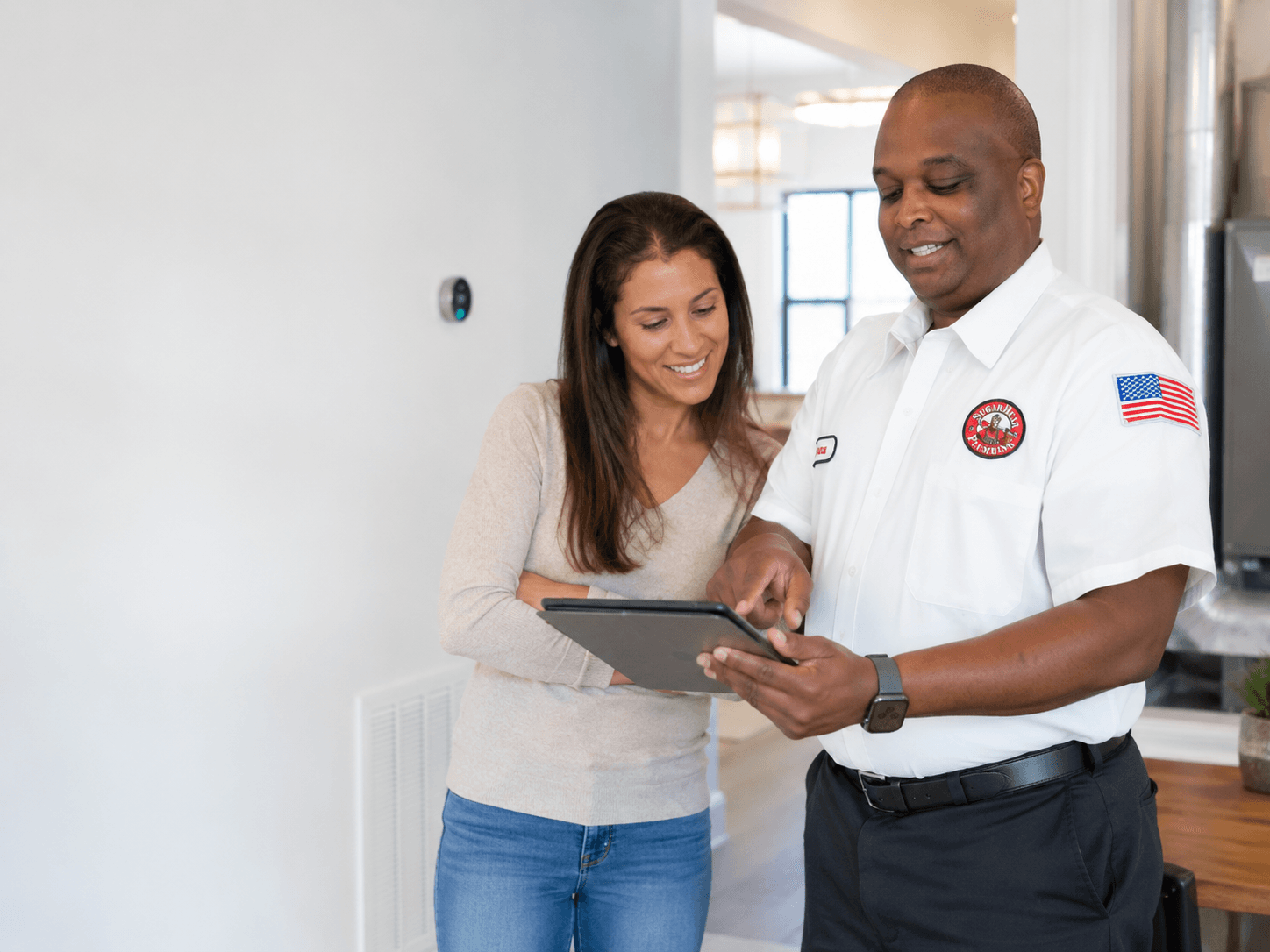 Sugar Bear technician reviewing a flat-rate quote with a homeowner