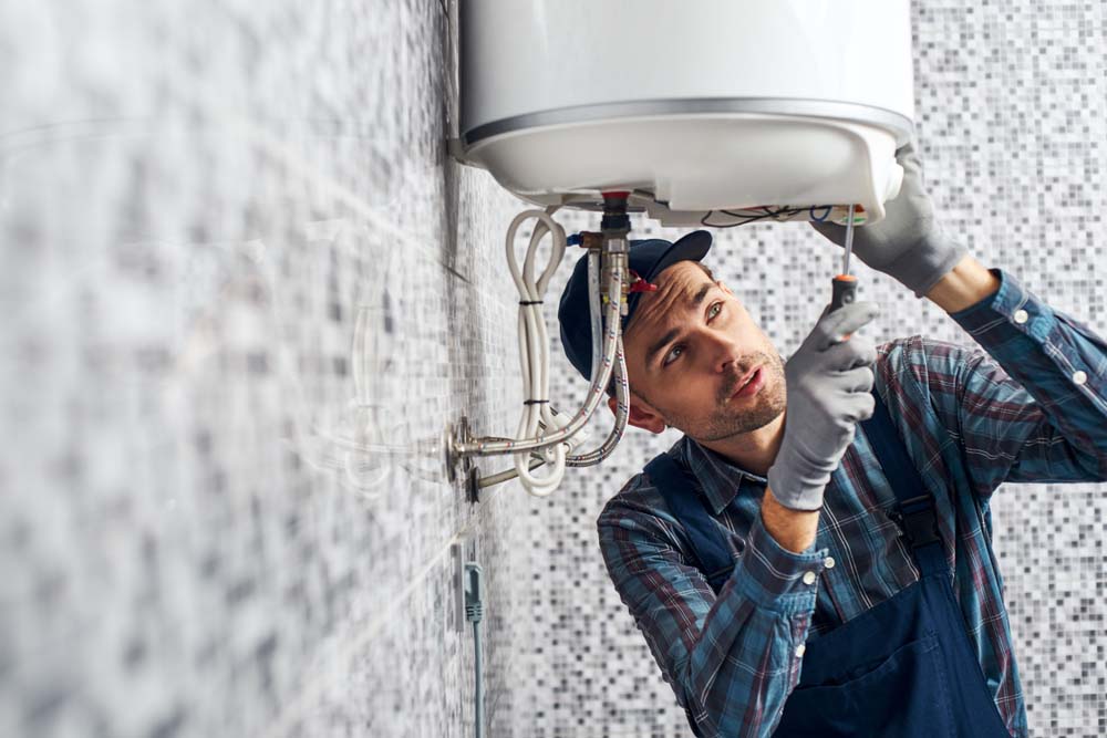 Sugar Bear technician servicing a water heater Sugar Bear technician servicing a water heater