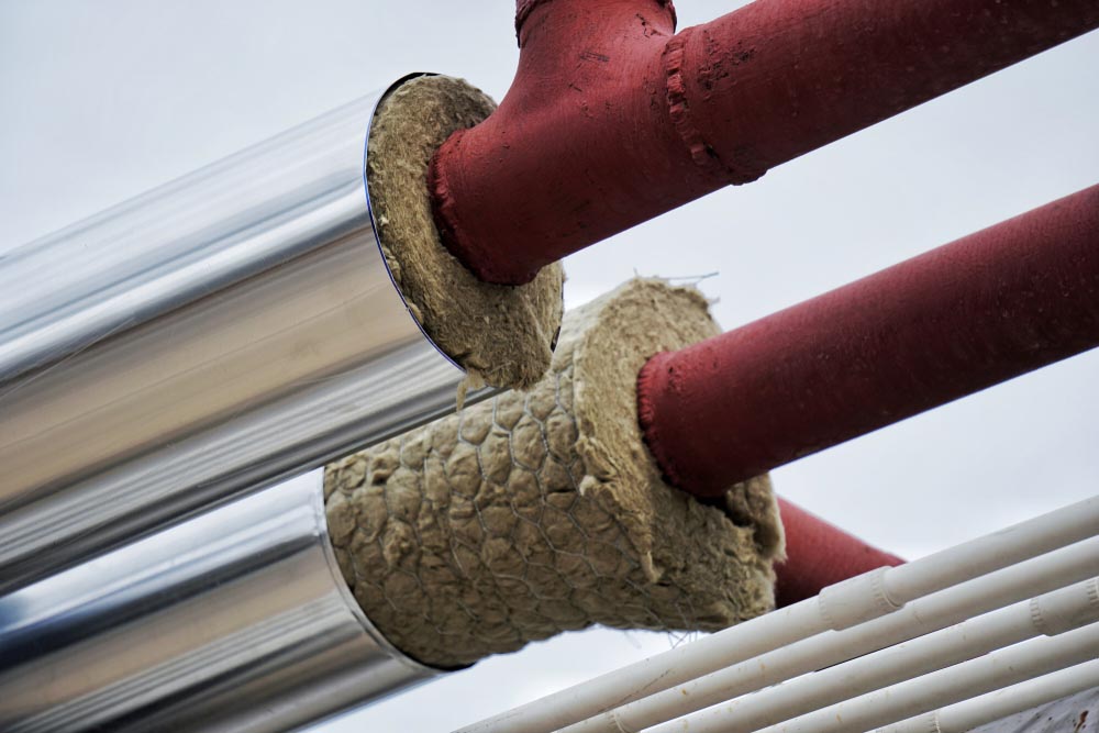 a person insulating a water heater a person insulating a water heater